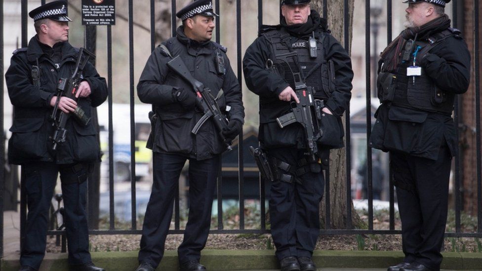 armed police stand outside downing street in London