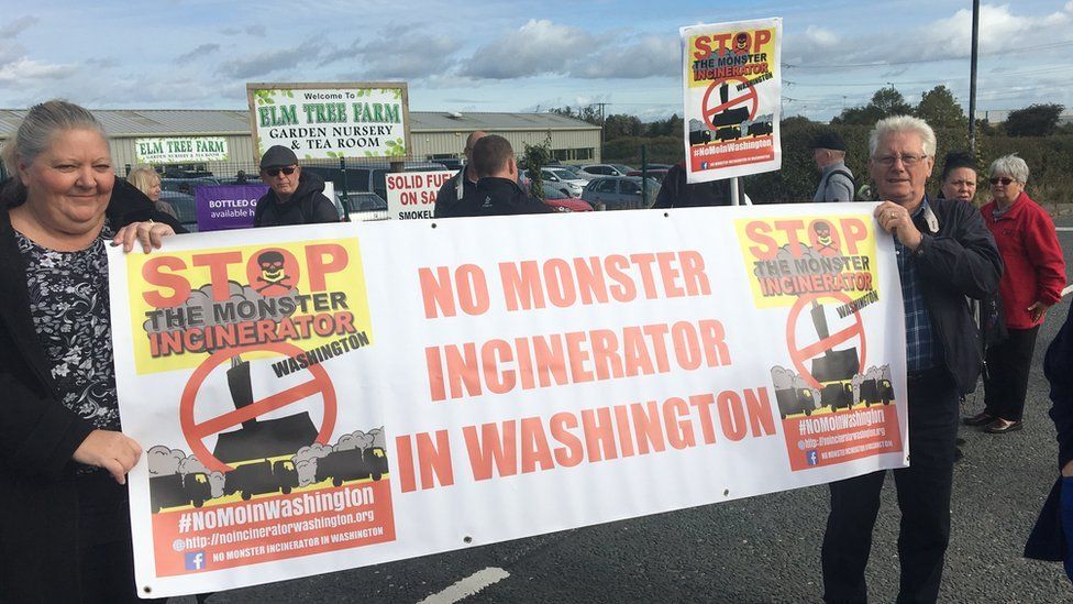 Protesters holding a banner saying 'No monster incinerator' during a November 2017 protest