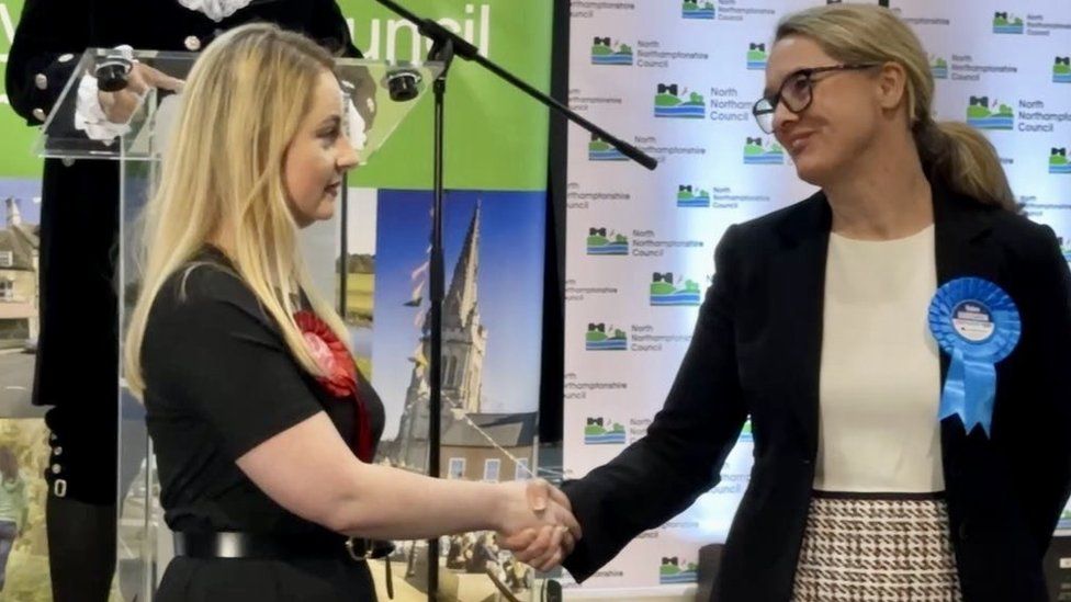 Labour's winning candidate in Wellingborough Gen Kitchen being congratulated by Conservative opponent Helen Harrison