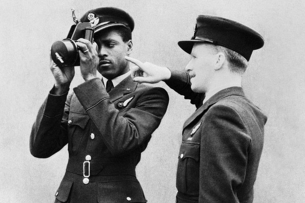 Johnny Smythe being instructed in the use of the sextant by a flying officer instructor