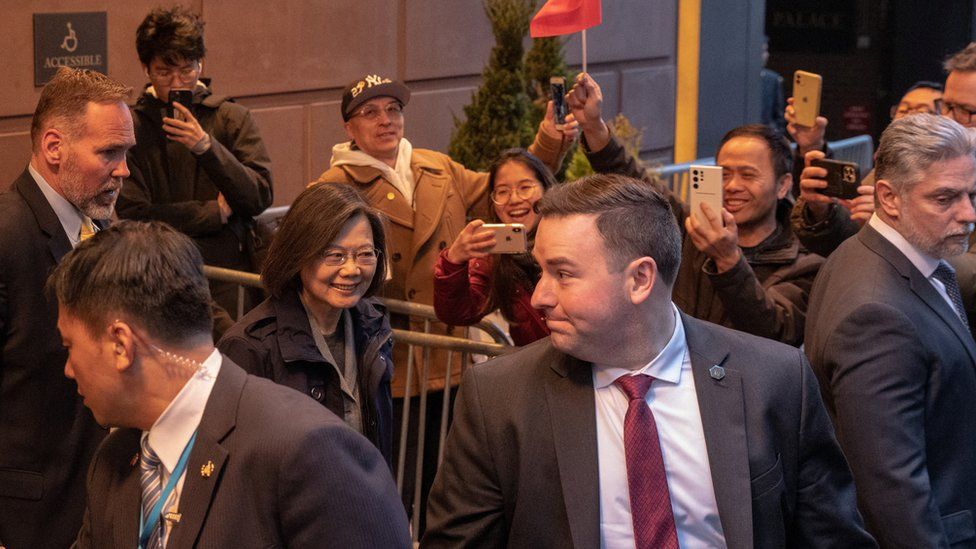 Bodyguards flank Taiwan President Tsai Ing-wen in front of supporters and protesters as she arrives at her New York hotel