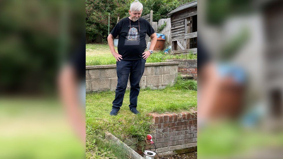 Howard Tubb-Johnson looks at a pump in his garden