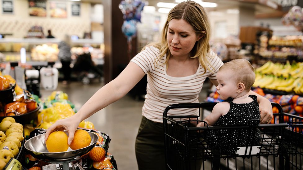 Woman looking at items in a supermarket