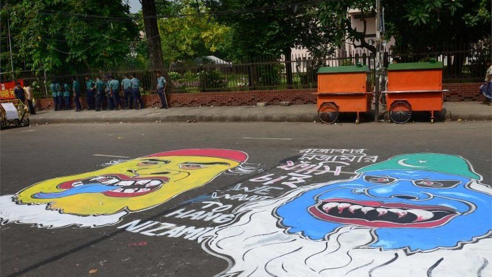 Bangladeshi security personnel gather near graffiti on a road after a review petition relating to Jamaat-e-Islami leader Motiur Rahman Nizami"s reprieve petition by The Supreme Court in Dhaka on May 5, 2016.