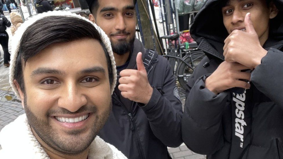 Shabaz Says taking a selfie with passers by on the streets of Birmingham.