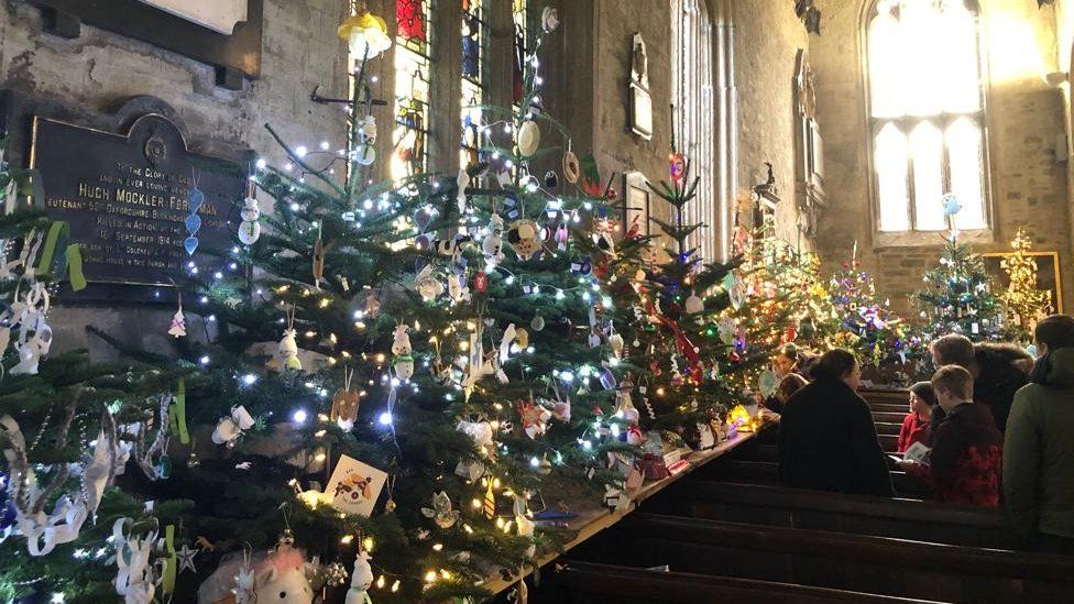 Church celebrates 13th Christmas tree festival - BBC News