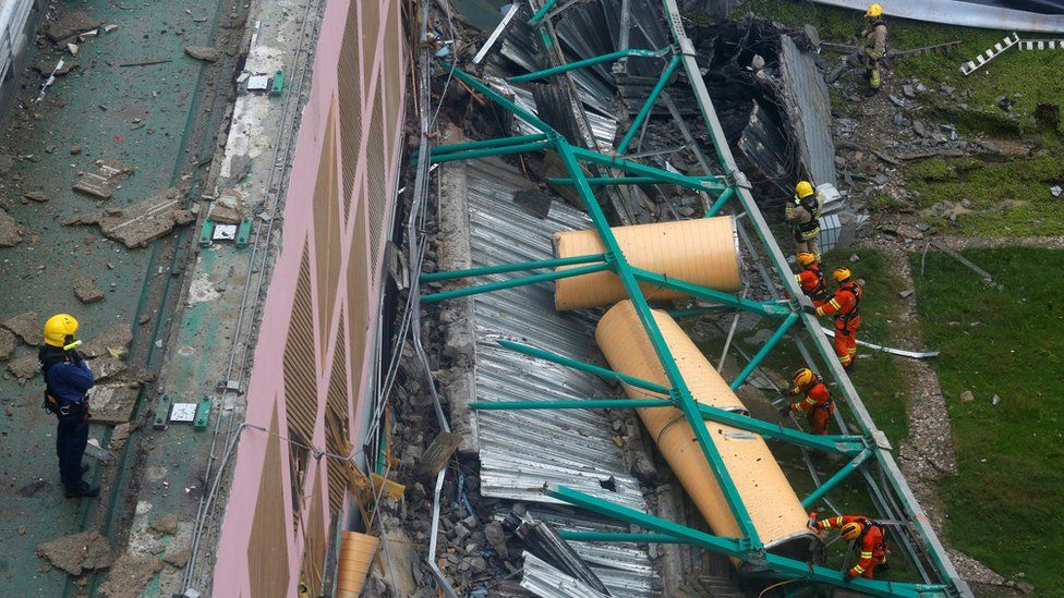 Rescuers search for casualties after the grass-covered roof of an indoor hall at a City University sports centre collapsed in Hong Kong