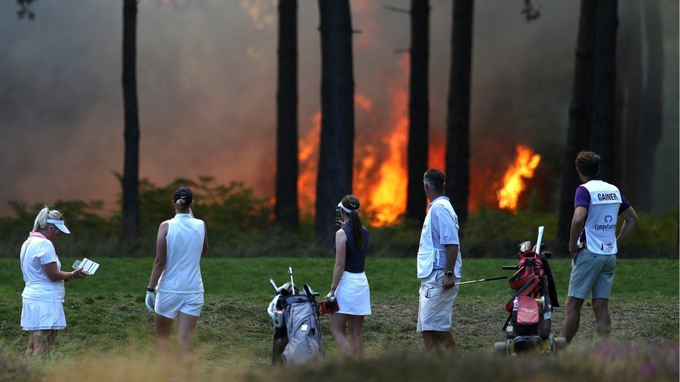 Golfers near the fire
