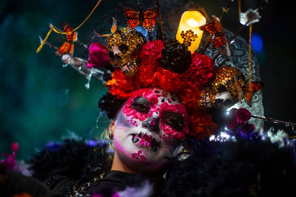 A person dressed in a costume participates in the Catrinas procession as part of the celebrations for the Day of the Dead, in Mexico City, Mexico, 22 October 2023.