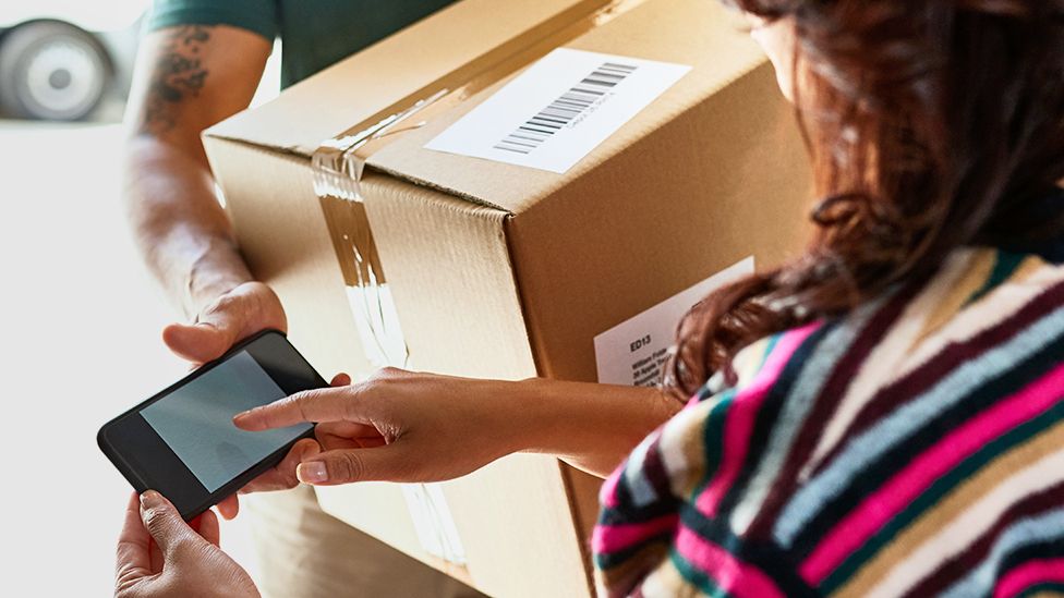 A parcel delivery being signed for