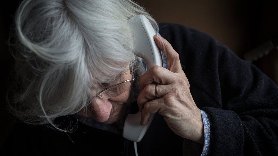 An elderly woman on the phone