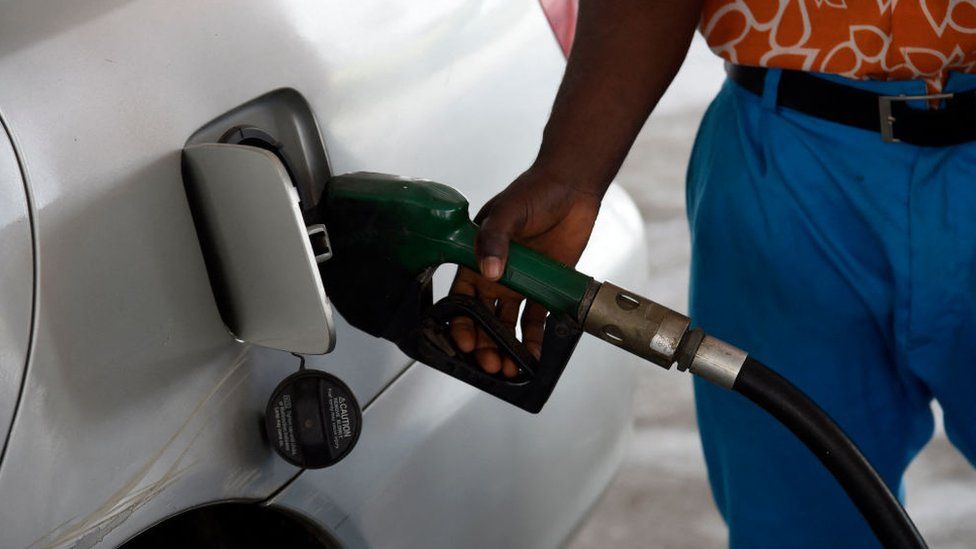 Man fills car petrol tank in Nigeria