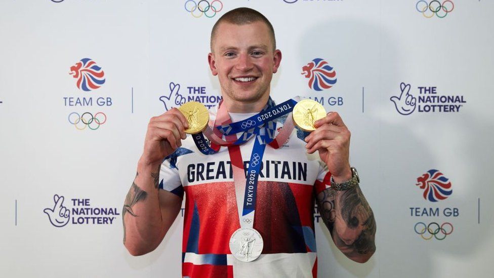 Adam Peaty with gold medals