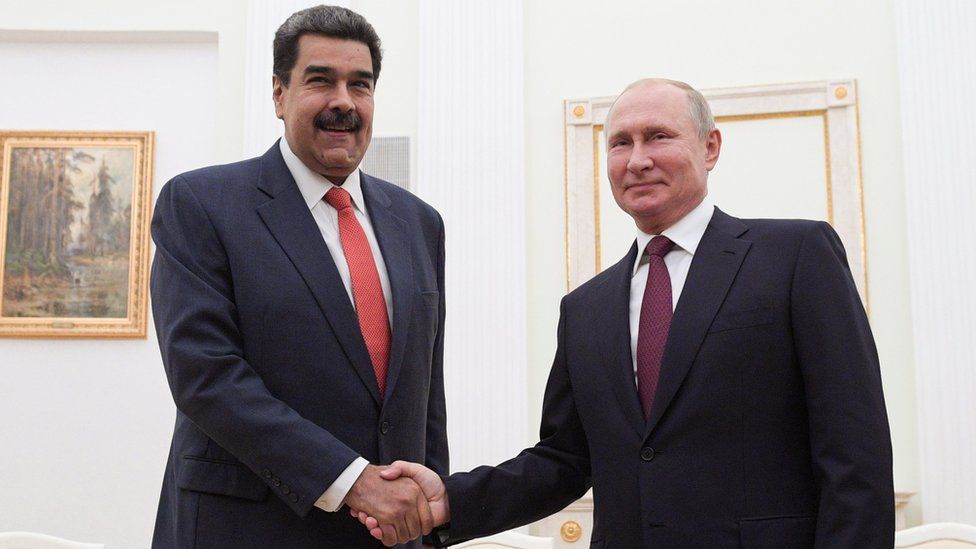 Russian President Vladimir Putin (R) and Venezuelan President Nicolas Maduro (L) shake hands during their meeting in the Kremlin