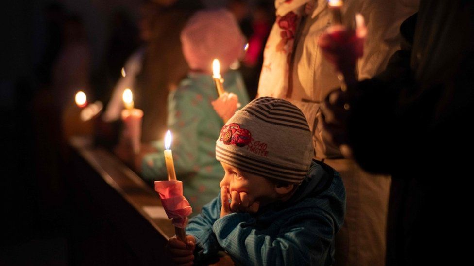 Worshippers held candles at a service in Bratislava, Slovakia