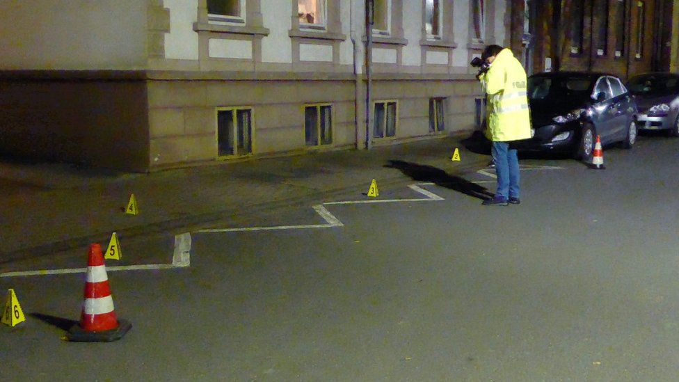 Police examine a street in Hamelin, Germany, on 21 Nov 2016 after a woman is found seriously injured