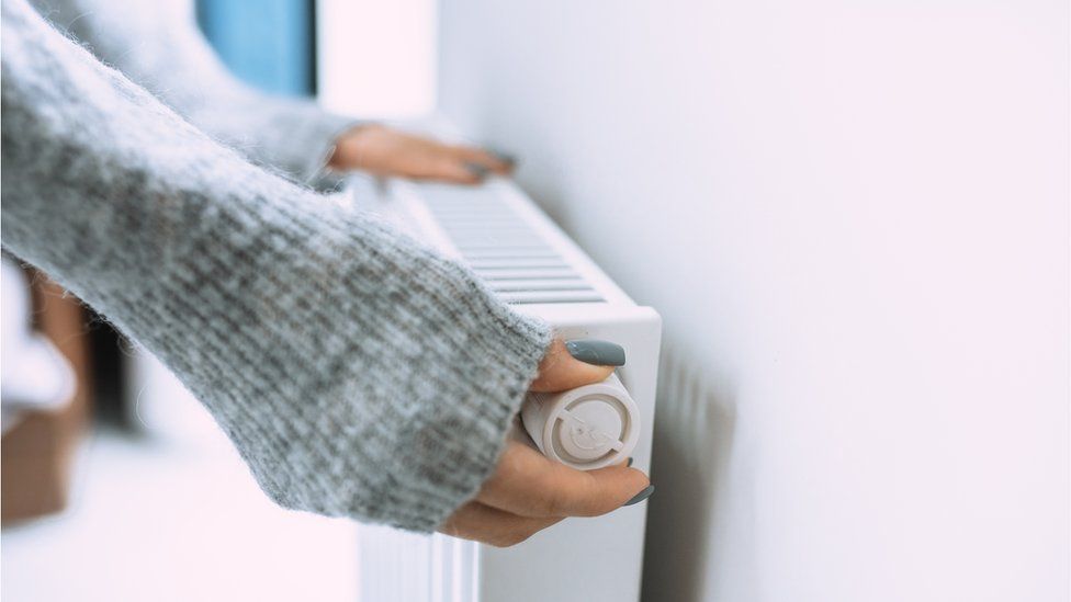 Woman changes somesthesia  connected  radiator