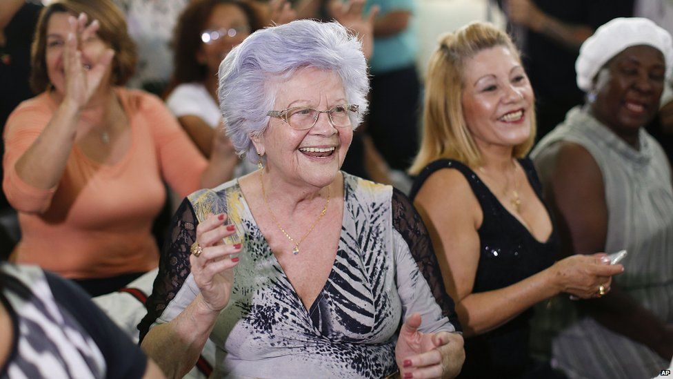 An 82-year-old woman cheers on her boyfriend as he competes in an elderly beauty contest in Sao Paulo