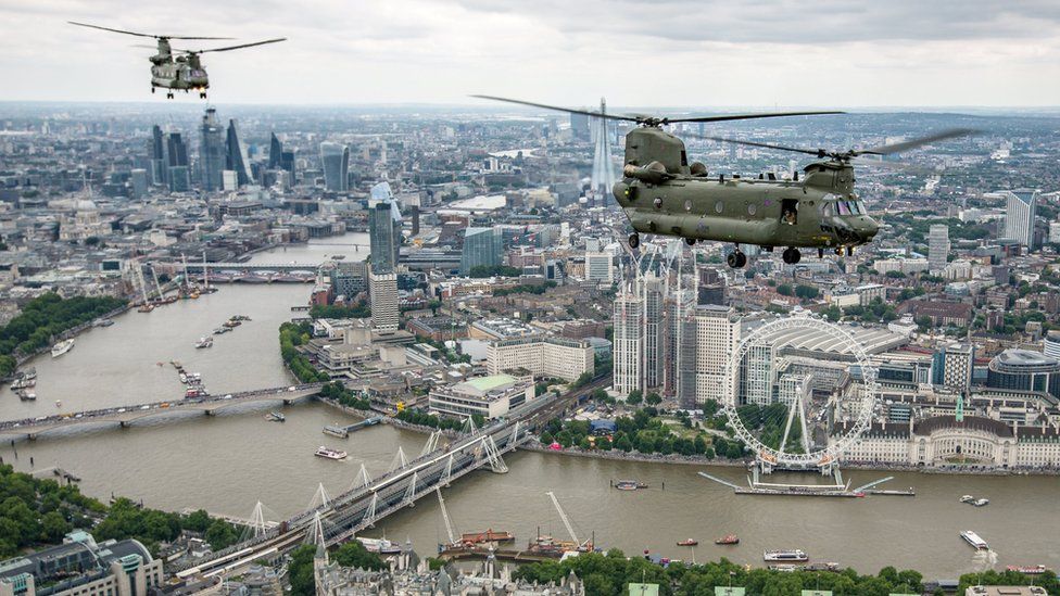 Military helicopters fly over London, heading for Buckingham Palace, to mark the centenary of the Royal Air Force in central London