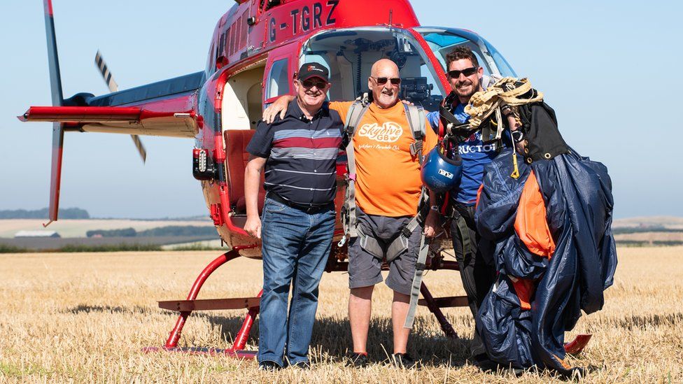 George Mattinson with instructor Alec Flint, right, and the helicopter pilot