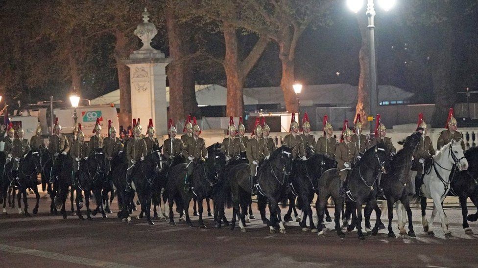 Members of the military on The Mall outside Buckingham Palace