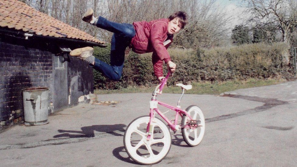 Boy leaps in the air while holding