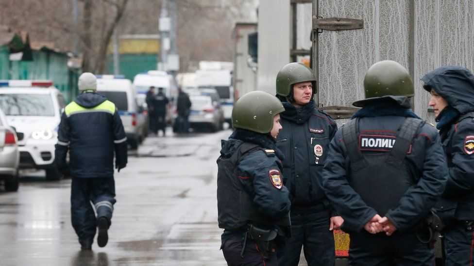 Russian policemen guard near "Menshevik" confectionery plant where a gunman opened fire in Moscow,