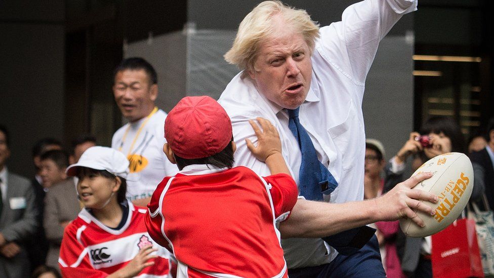 Boris Johnson knocks child to ground in touch rugby - BBC News