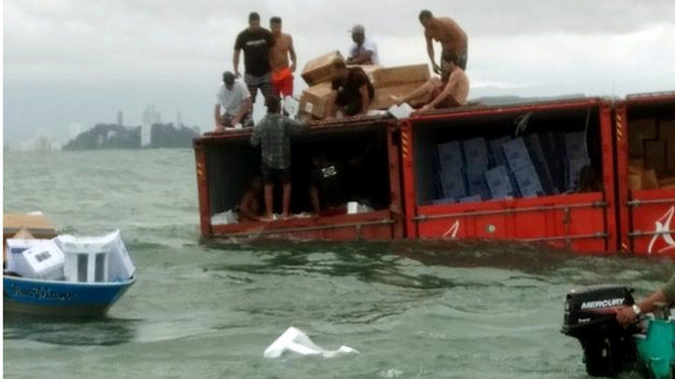 Police photo showing people looting containers from Log-In Pantanal off the coast of Santos, Sao Paulo state, Brazil