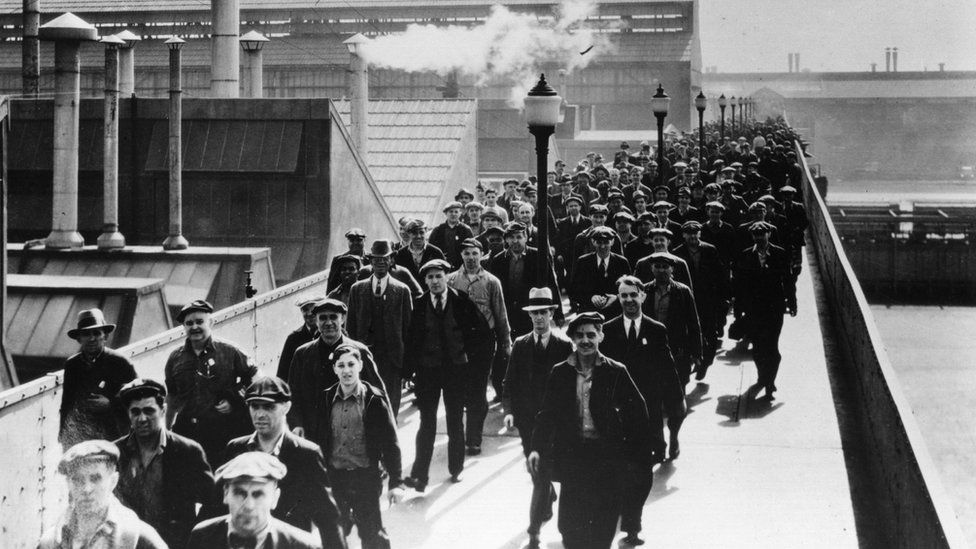 circa 1930: Workers leaving the Ford Motor works in Detroit, USA