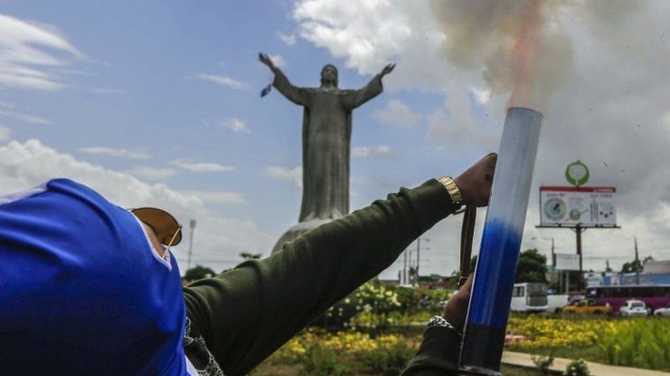 An opposition demonstrator fires a home-made mortar in front of the "Cristo Rey" monument, during a nationwide march called "United we are a volcano" in Managua on July 12, 2018.