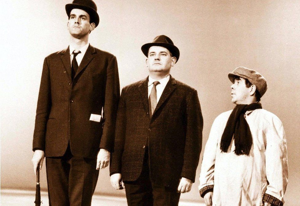 Fellow comedians John Cleese, Ronnie Barker and Ronnie Corbett in the class sketch, which was first broadcast on The Frost Report in 1966