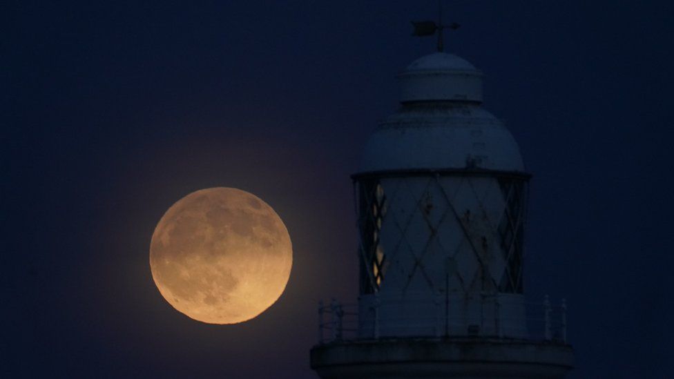 Wolf moon seen over St Mary's lighthouse at Whitley Bay in Northumberland