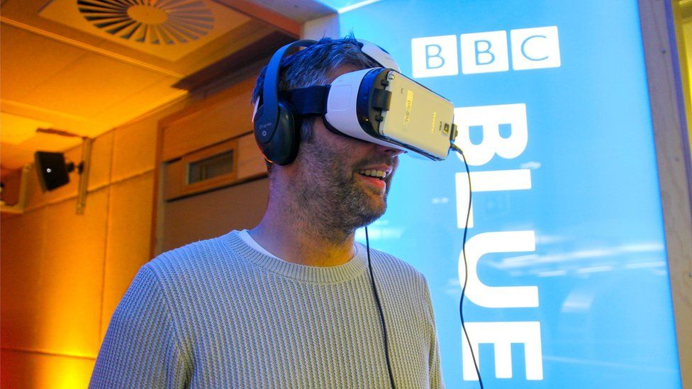 A man watches VR content using the Samsung Gear VR headset