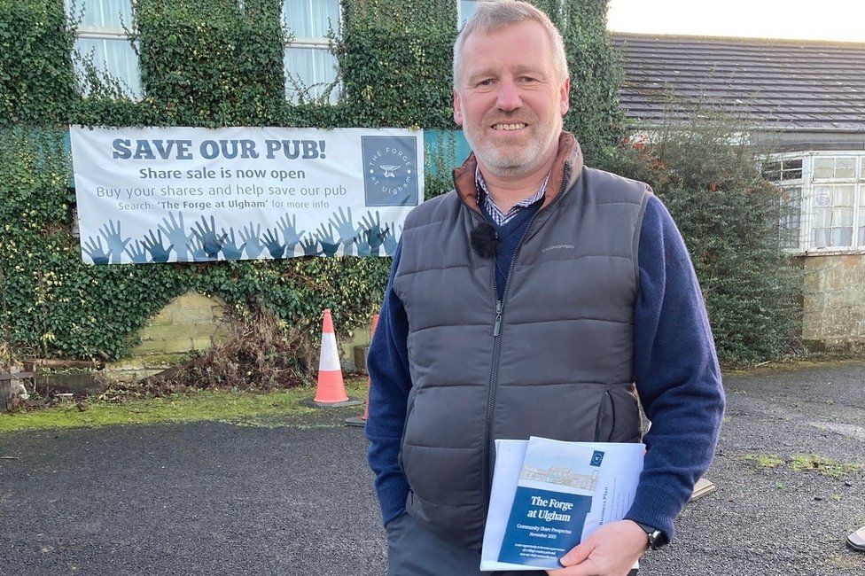 Dave Wilson and The Forge at Ulgham, with a Save our Pub sign in the background