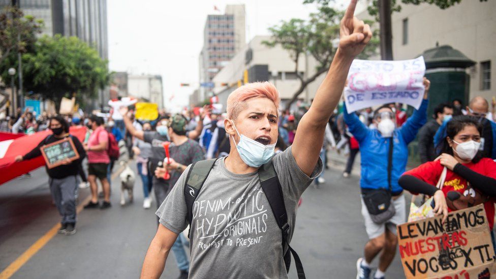 A supporter of ousted Peruvian President Martin Vizcarra, who was removed in an impeachment vote late Monday, demonstrates against the new government in Lima on 10 November 2020