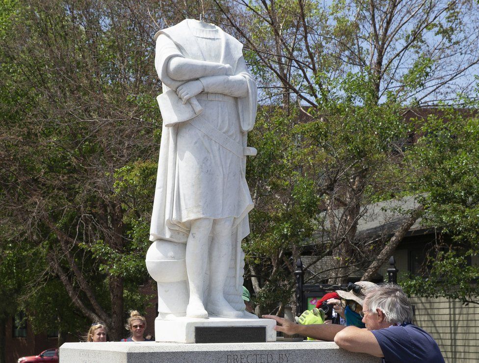 City employees inspect the decapitated statue of Christopher Columbus in Columbus Park in Boston, Massachusetts, 10 June 2020