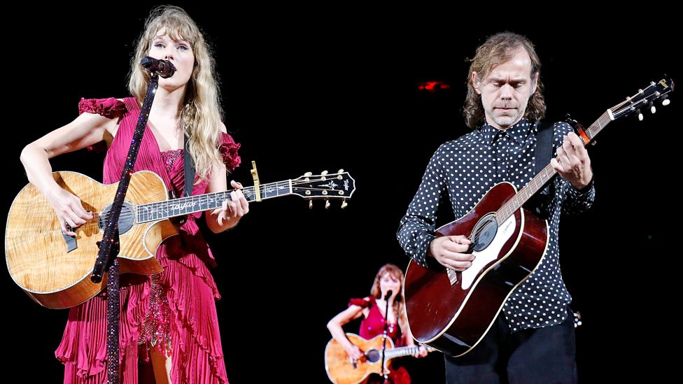 Taylor Swift and Aaron Dessner perform onstage during "Taylor Swift | The Eras Tour" at Raymond James Stadium on April 14, 2023 in Tampa, Florida