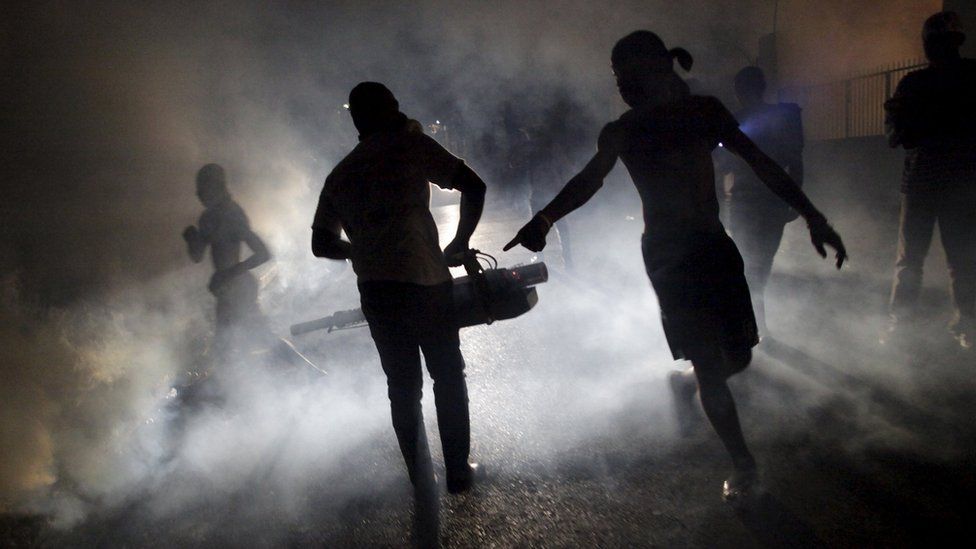 A worker of the Ministry of Public Health and Population fumigates in the street against mosquito breeding in Port-au-Prince, Haiti, February 15, 2016