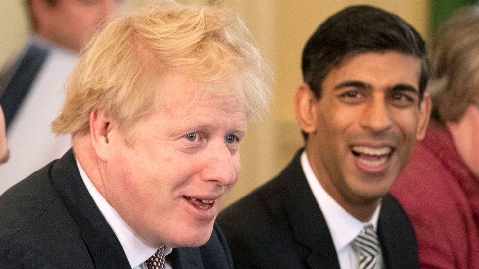 Britain's Prime Minister Boris Johnson speaks during his first Cabinet meeting next to a new appointed Chancellor of the Exchequer Rishi Sunak,