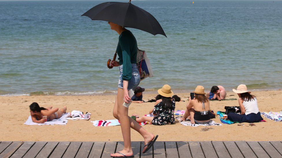People flock to St Kilda beach as a heat wave sweeps across Victoria, Australia, 18 December, 2019.