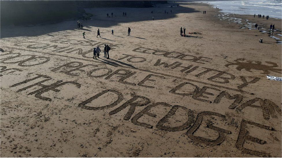 A message written in the sand on the beach