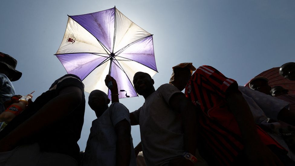 Voters under an umbrella in Yola, Nigeria - Saturday 25 February 2023