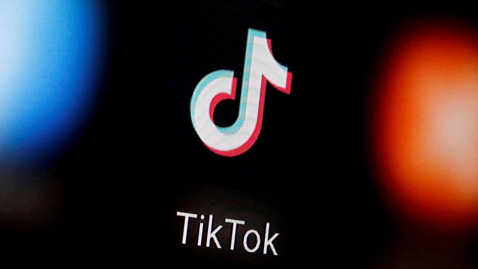 A TikTok logo on a smartphone