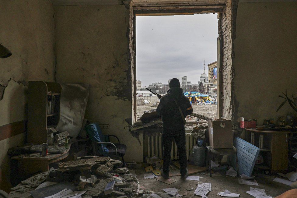 A member of the Territorial Defense Forces of Ukraine stands inside the damaged Kharkiv regional administration building in the aftermath of a shelling in downtown Kharkiv, Ukraine, 01 March 2022.