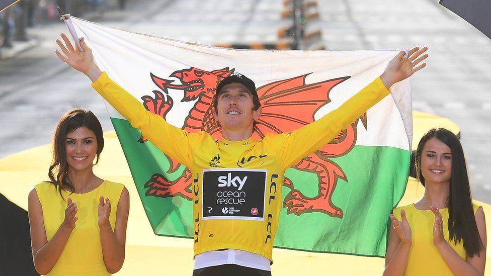 Geraint Thomas hold Welsh flag on Tour de France winner's podium in Paris
