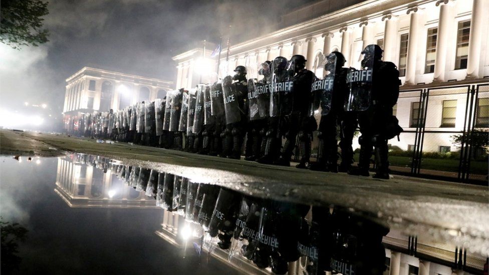 Law enforcement officers guard during a protest