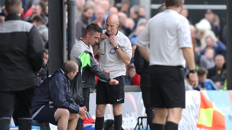 Fourth official Wayne Barratt (R) took over when referee James Adcock retired with an injury