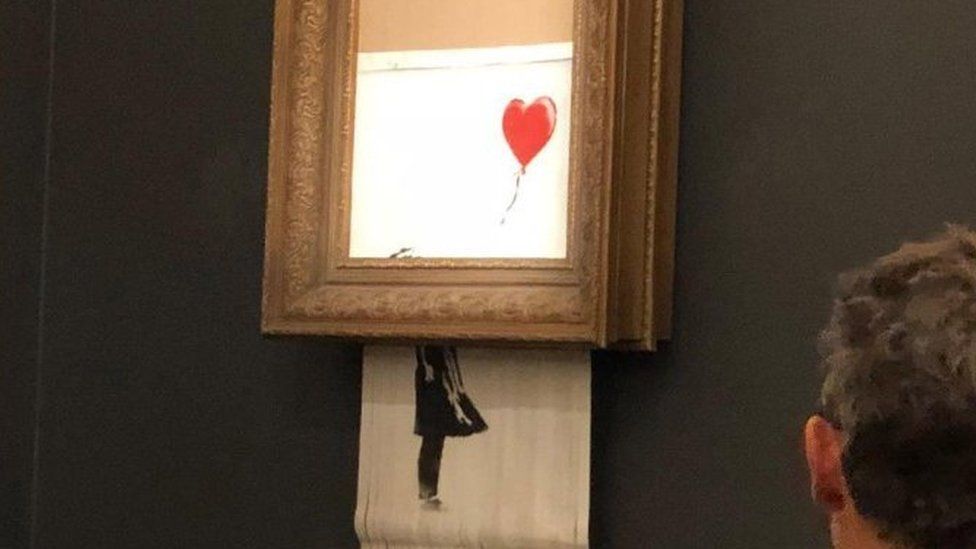 Banksy's Girl With Red Balloon mysteriously shreds after its sale