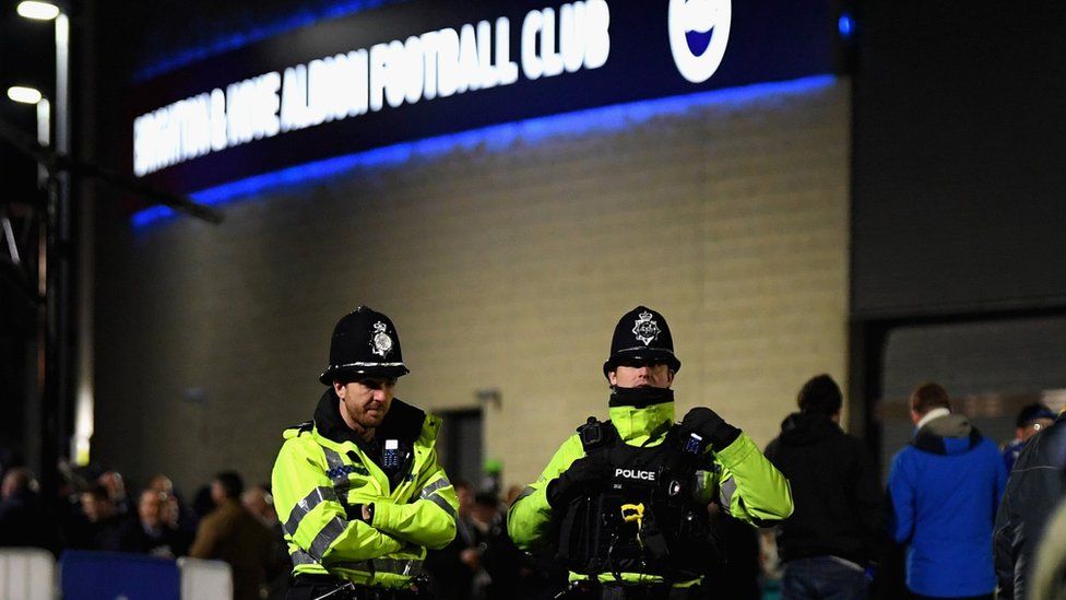 Police stand outside Brighton's Amex Stadium